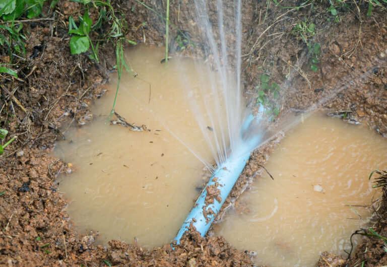 Water pipe break, leaking from hole in a hose,selective focus